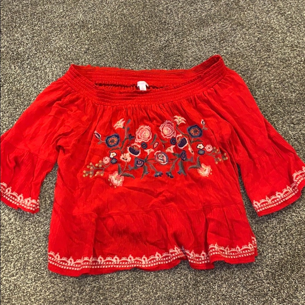a red floral top that is off the shoulder